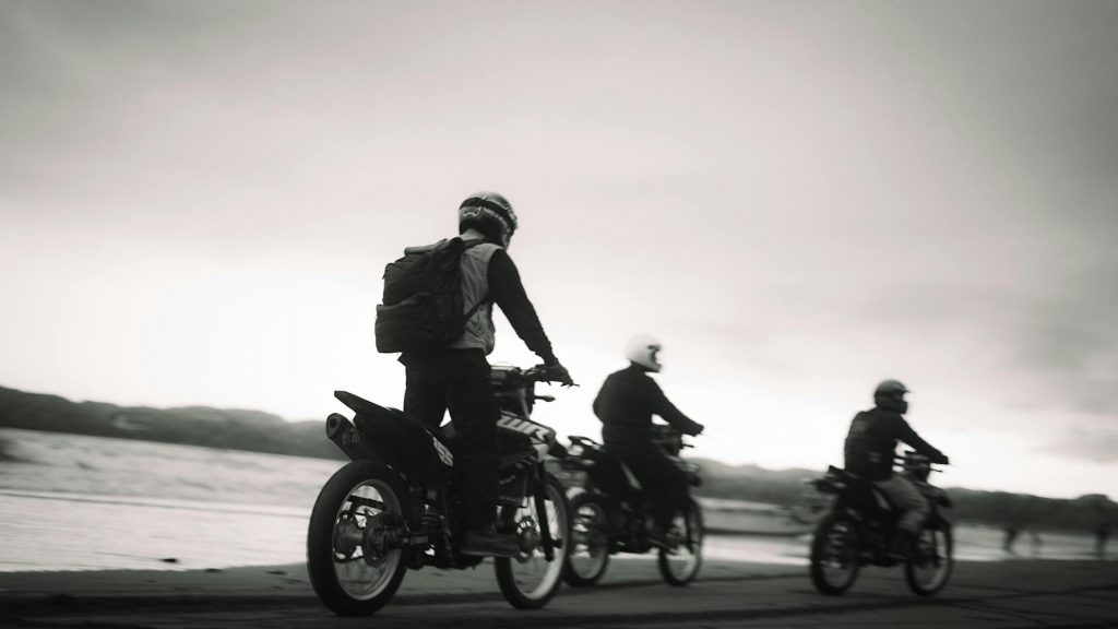 motorcycle riders cruising along the seashore